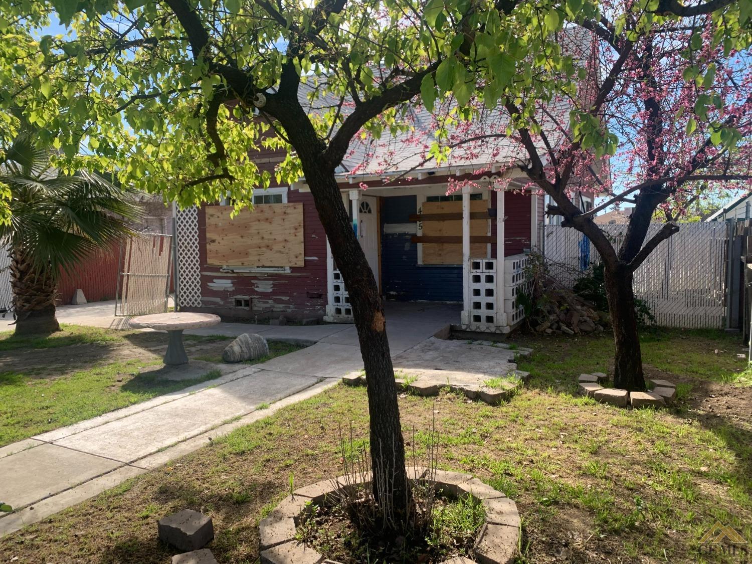 Undisclosed Address Bakersfield, CA 93308 - Photo 2 of 10 a tree in a yard next to a building