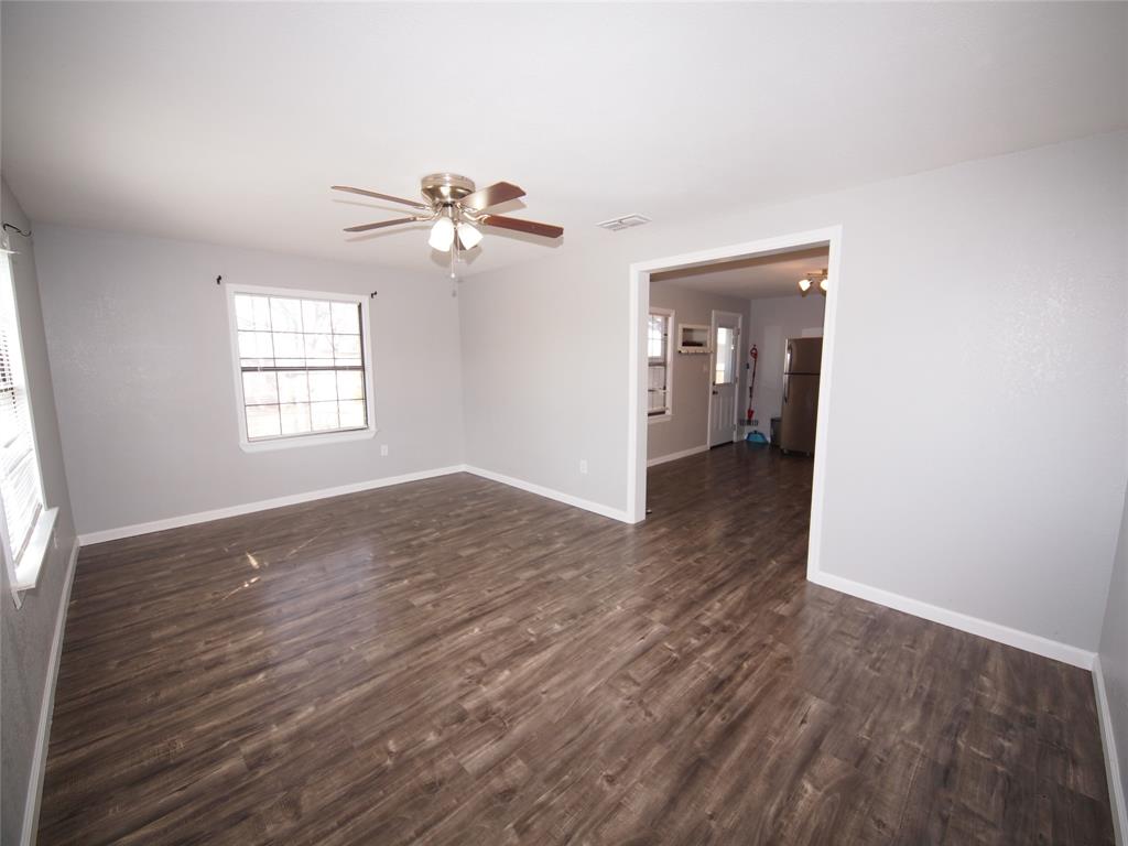 1327 Old Jacksboro Road Graham, TX 76450 - Photo 8 of 33 a view of empty room with wooden floor and fan