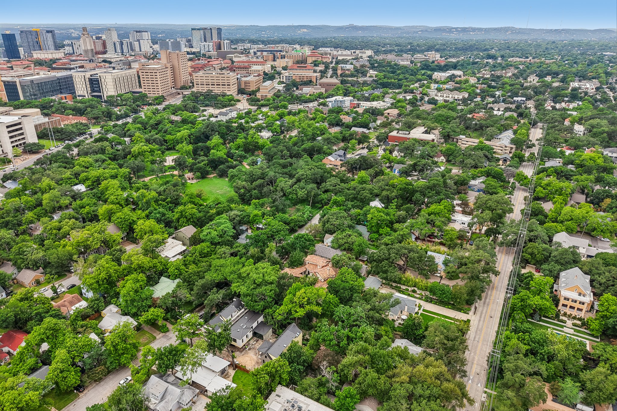 801 East 32nd Street Austin, TX 78705 - Photo 9 of 13 An aerial perspective reveals a verdant urban landscape, seamlessly blending residential areas with a vibrant cityscape.