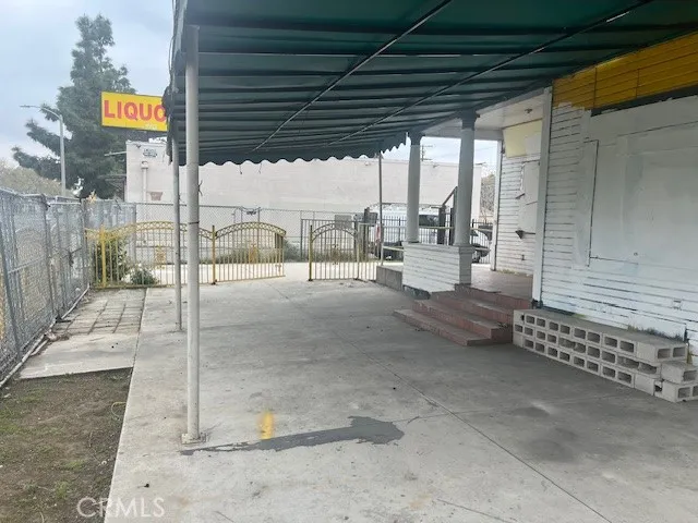 a view of a porch with a table and chairs