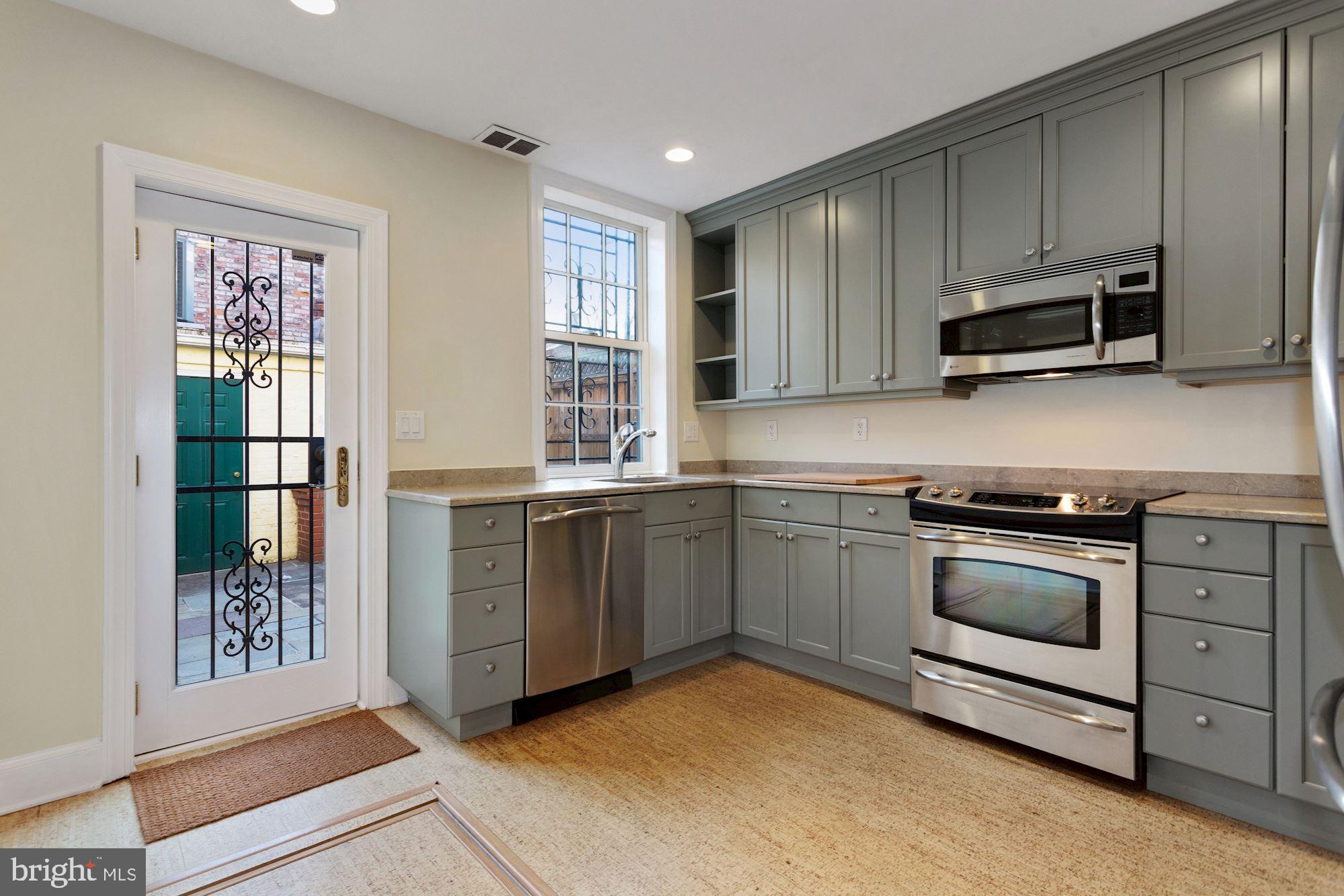315 Constitution Avenue Northeast Washington, DC 20002 - Photo 11 of 32 a kitchen with stainless steel appliances granite countertop a stove a sink and a microwave