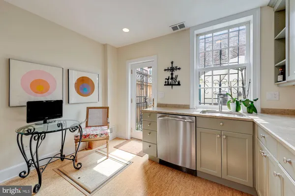 a view of workspace with wooden floor windows cabinet and flat screen tv