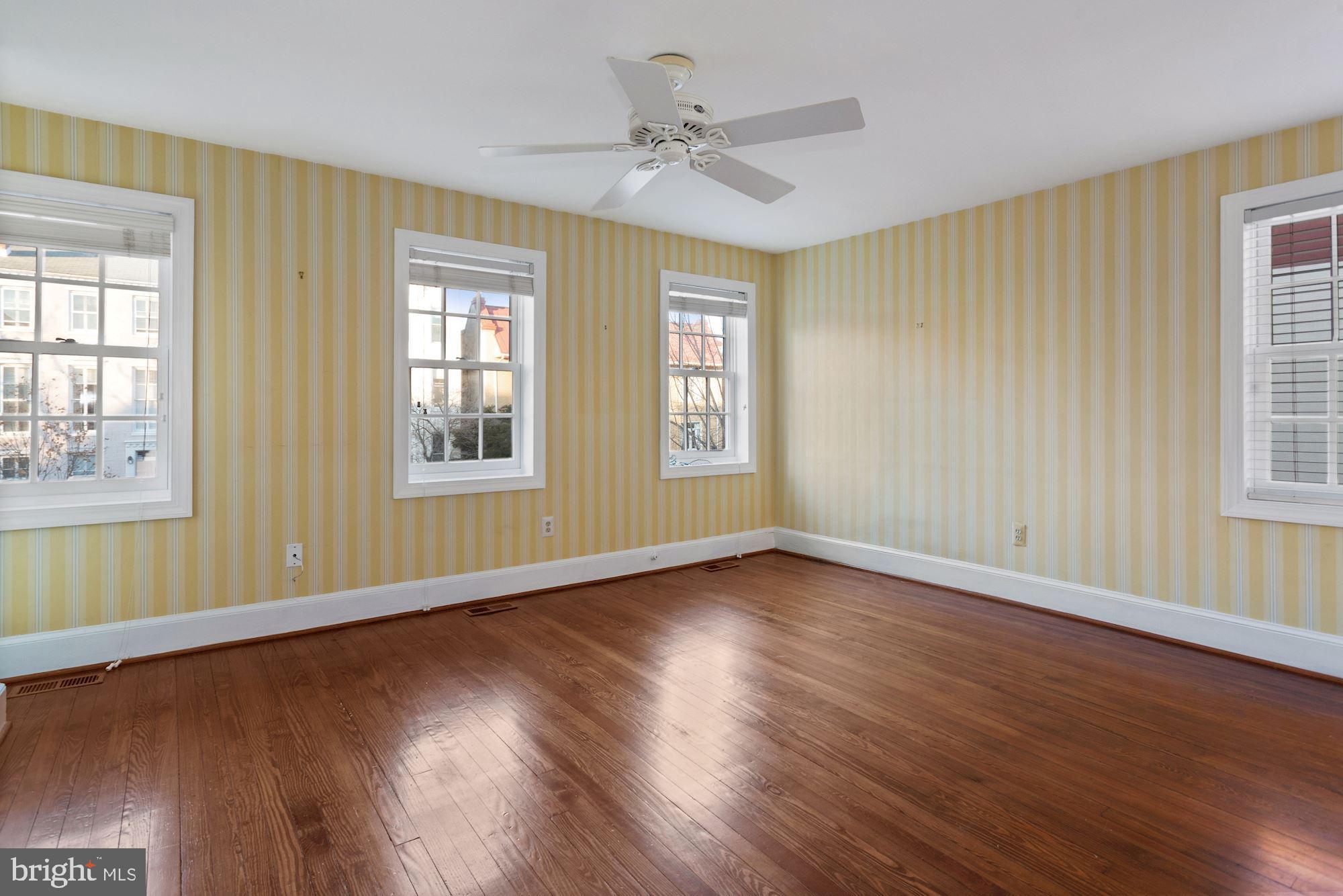 315 Constitution Avenue Northeast Washington, DC 20002 - Photo 20 of 32 a view of an empty room with wooden floor and a window