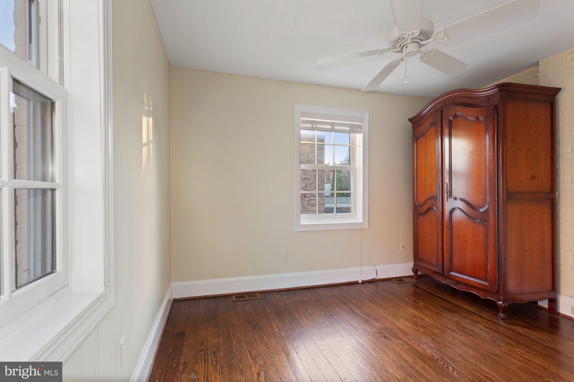 315 Constitution Avenue Northeast Washington, DC 20002 - Photo 25 of 32 an empty room with wooden floor closet and windows