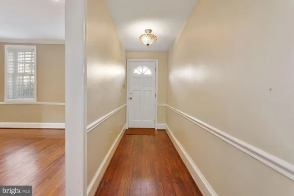 a view of a hallway view with wooden floor and staircase