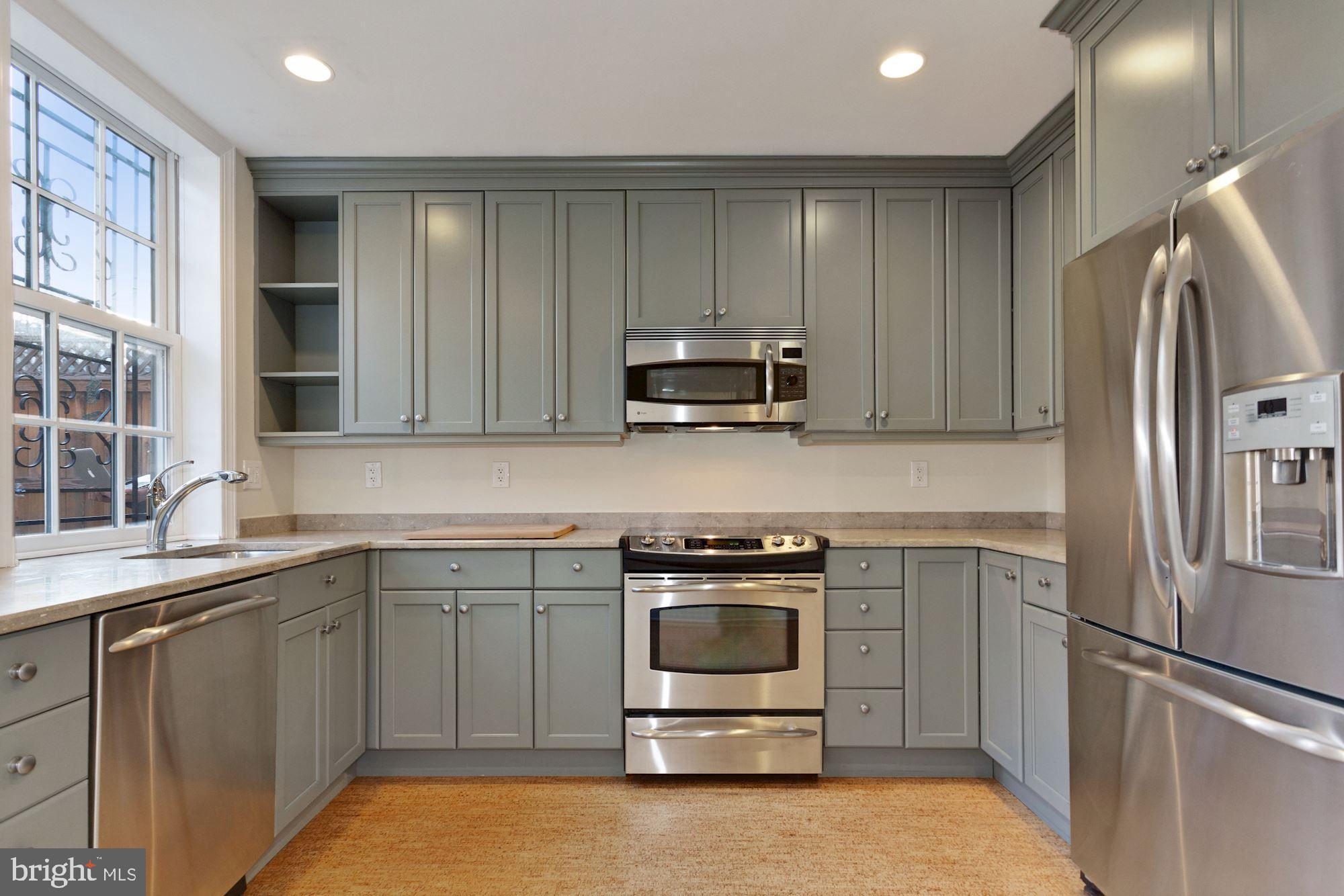 315 Constitution Avenue Northeast Washington, DC 20002 - Photo 10 of 32 a kitchen with a sink stainless steel appliances and cabinets