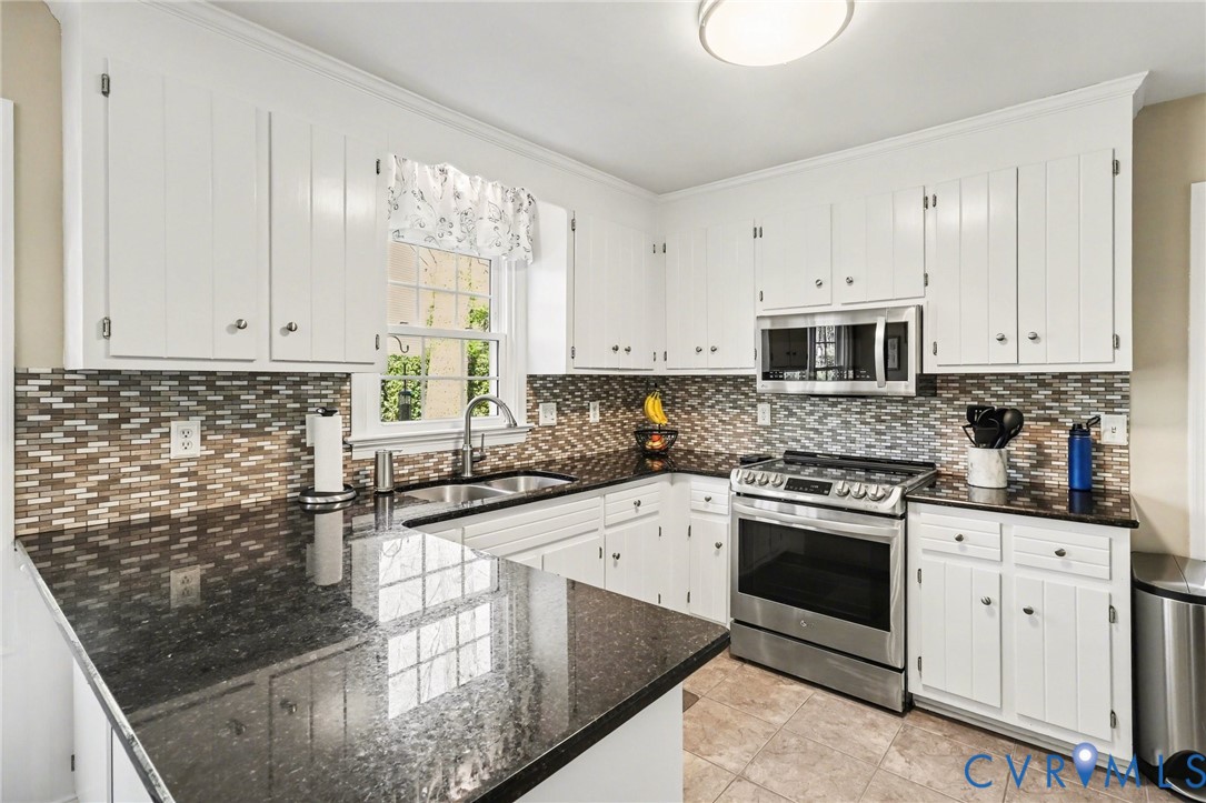 548 Glenmeadow Road Midlothian, VA 23114 - Photo 8 of 31 a kitchen with stainless steel appliances granite countertop a stove a sink and white cabinets
