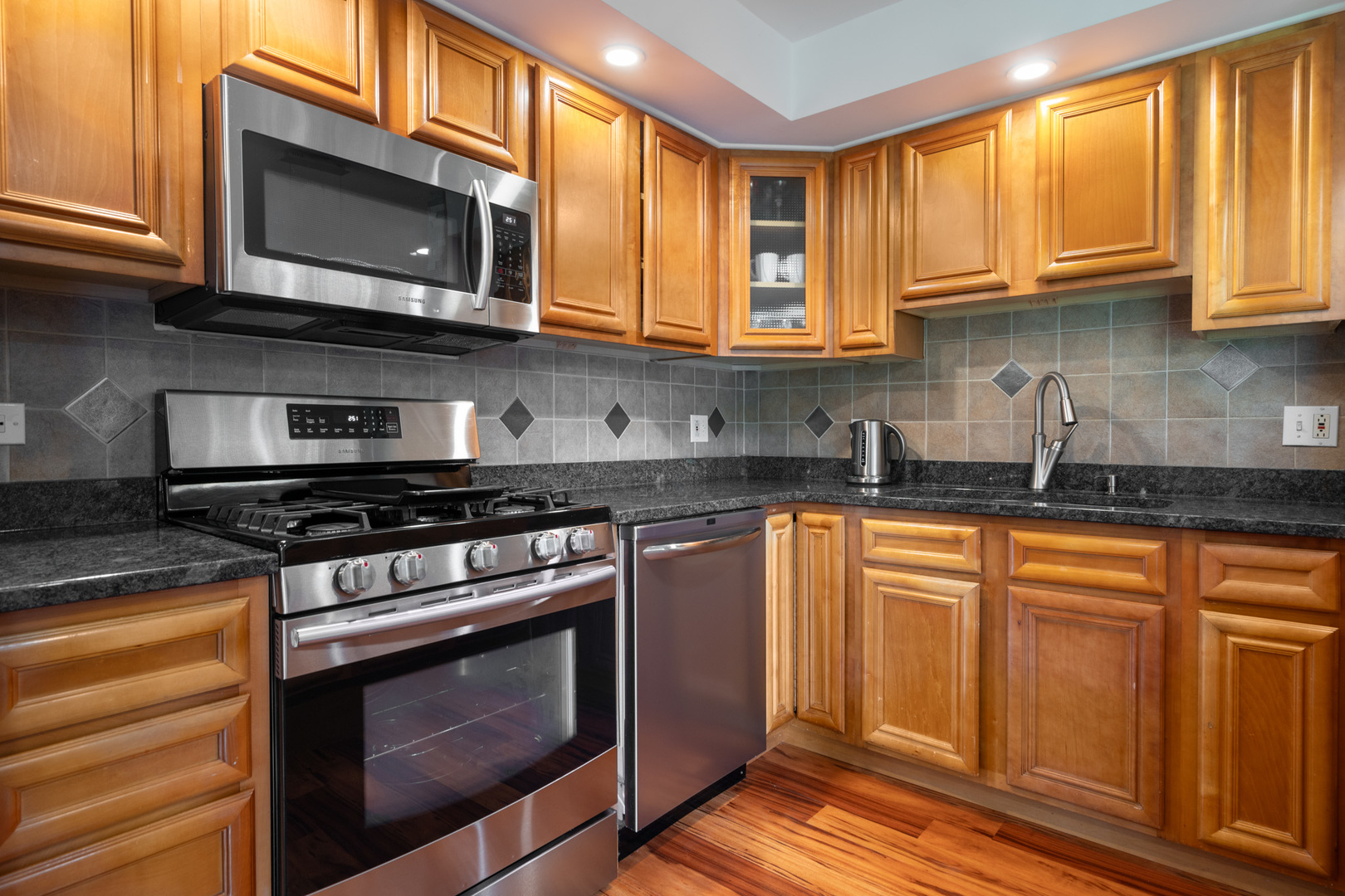 12 Cour Monnet Palos Hills, IL 60465 - Photo 10 of 27 a kitchen with stainless steel appliances granite countertop a stove microwave and cabinets