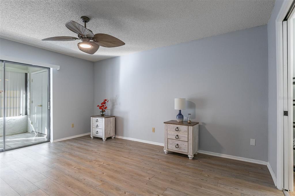 19029 US Highway 19 North, Unit 10C Clearwater, FL 33764 - Photo 13 of 61 a view of a livingroom with wooden floor and a ceiling fan