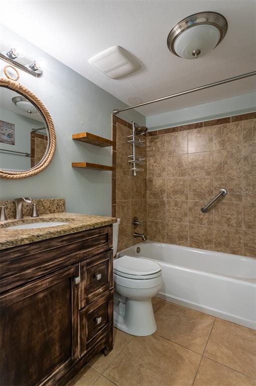 19029 US Highway 19 North, Unit 10C Clearwater, FL 33764 - Photo 23 of 61 a bathroom with a granite countertop toilet sink and mirror