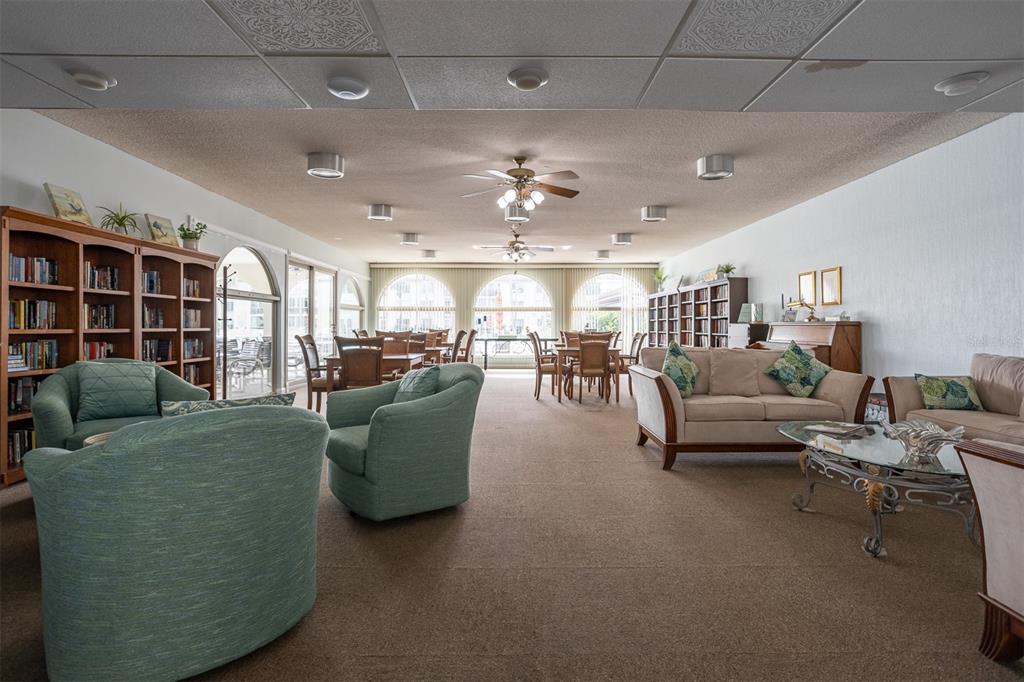 19029 US Highway 19 North, Unit 10C Clearwater, FL 33764 - Photo 45 of 61 a living room with furniture and a chandelier