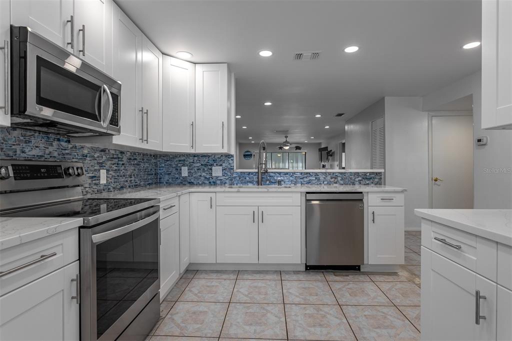 19029 US Highway 19 North, Unit 10C Clearwater, FL 33764 - Photo 6 of 61 a kitchen with a sink stove and microwave