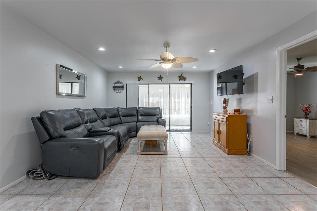 19029 US Highway 19 North, Unit 10C Clearwater, FL 33764 - Photo 9 of 61 a living room with furniture and a flat screen tv