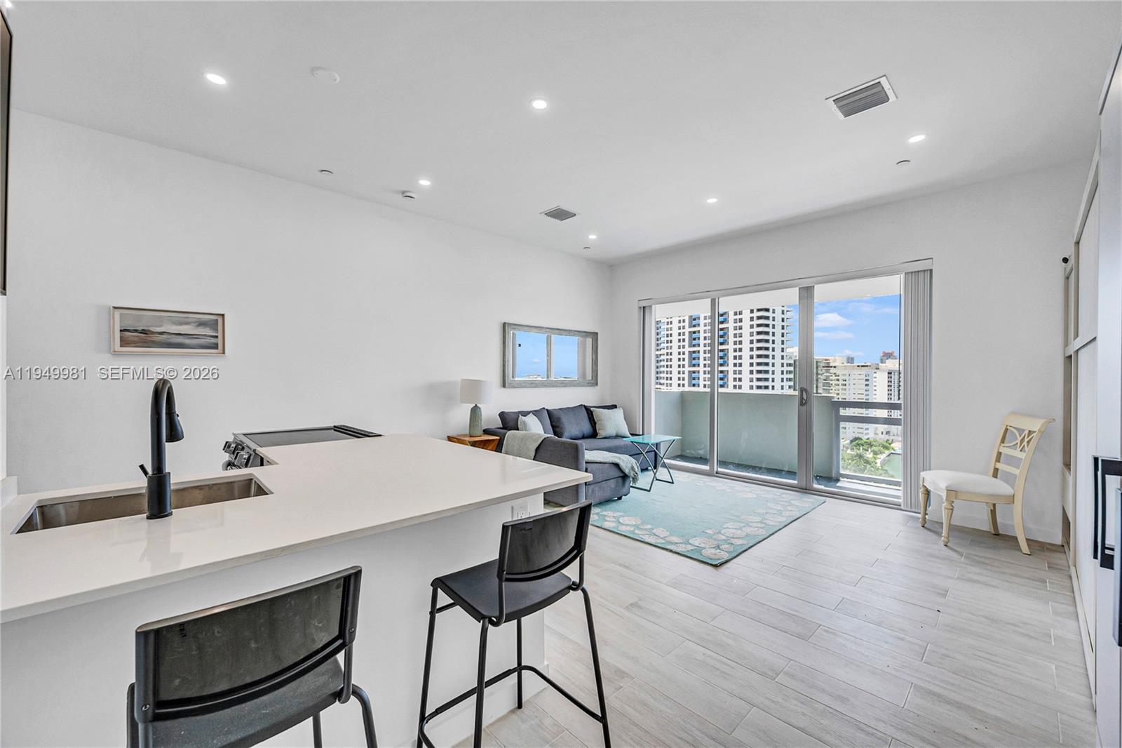 1500 Bay Road, Unit 1536S Miami Beach, FL 33139 - Photo 13 of 34 a view of a dining room with furniture and wooden floor