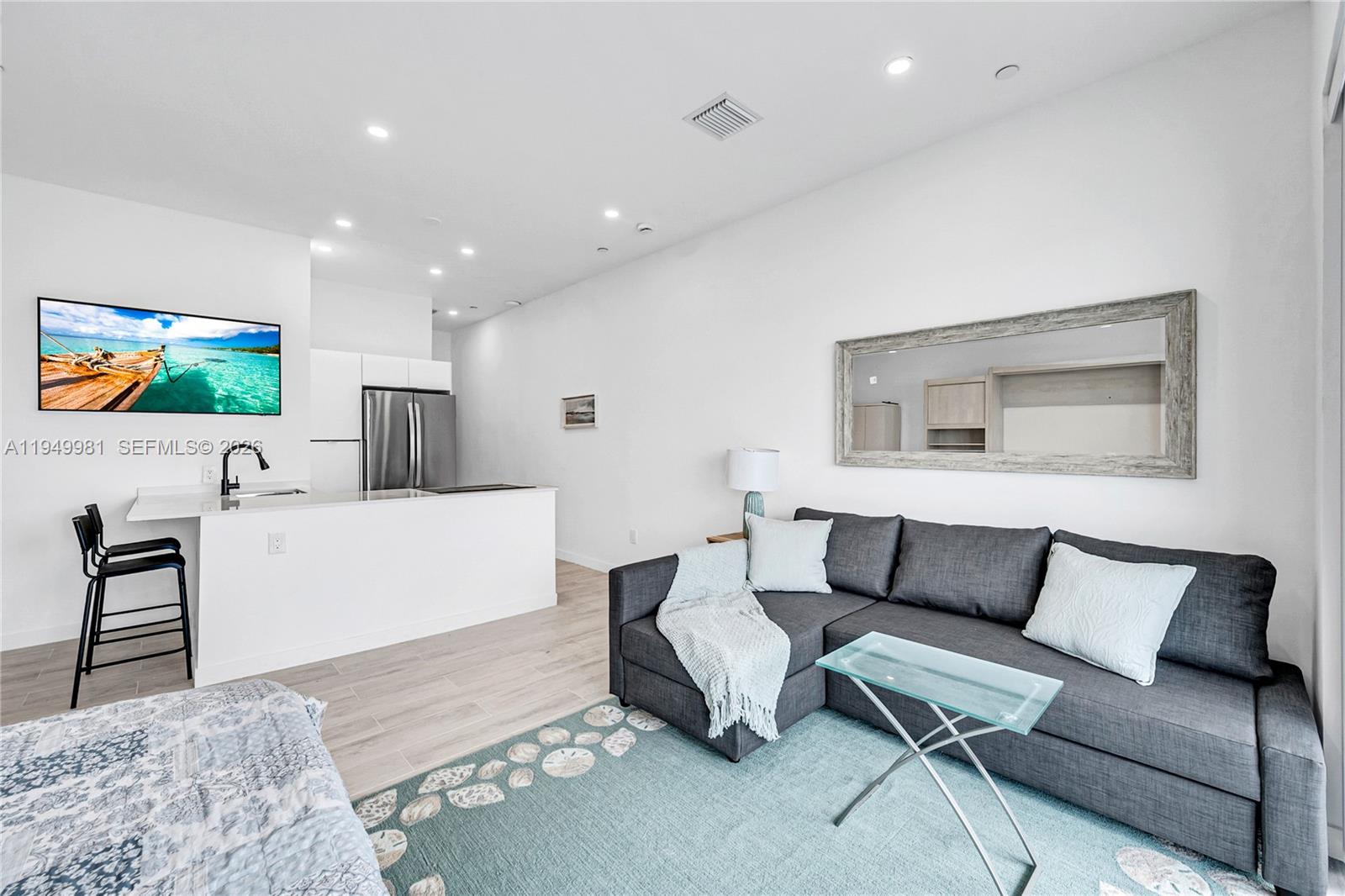 1500 Bay Road, Unit 1536S Miami Beach, FL 33139 - Photo 14 of 34 a living room with furniture and a flat screen tv