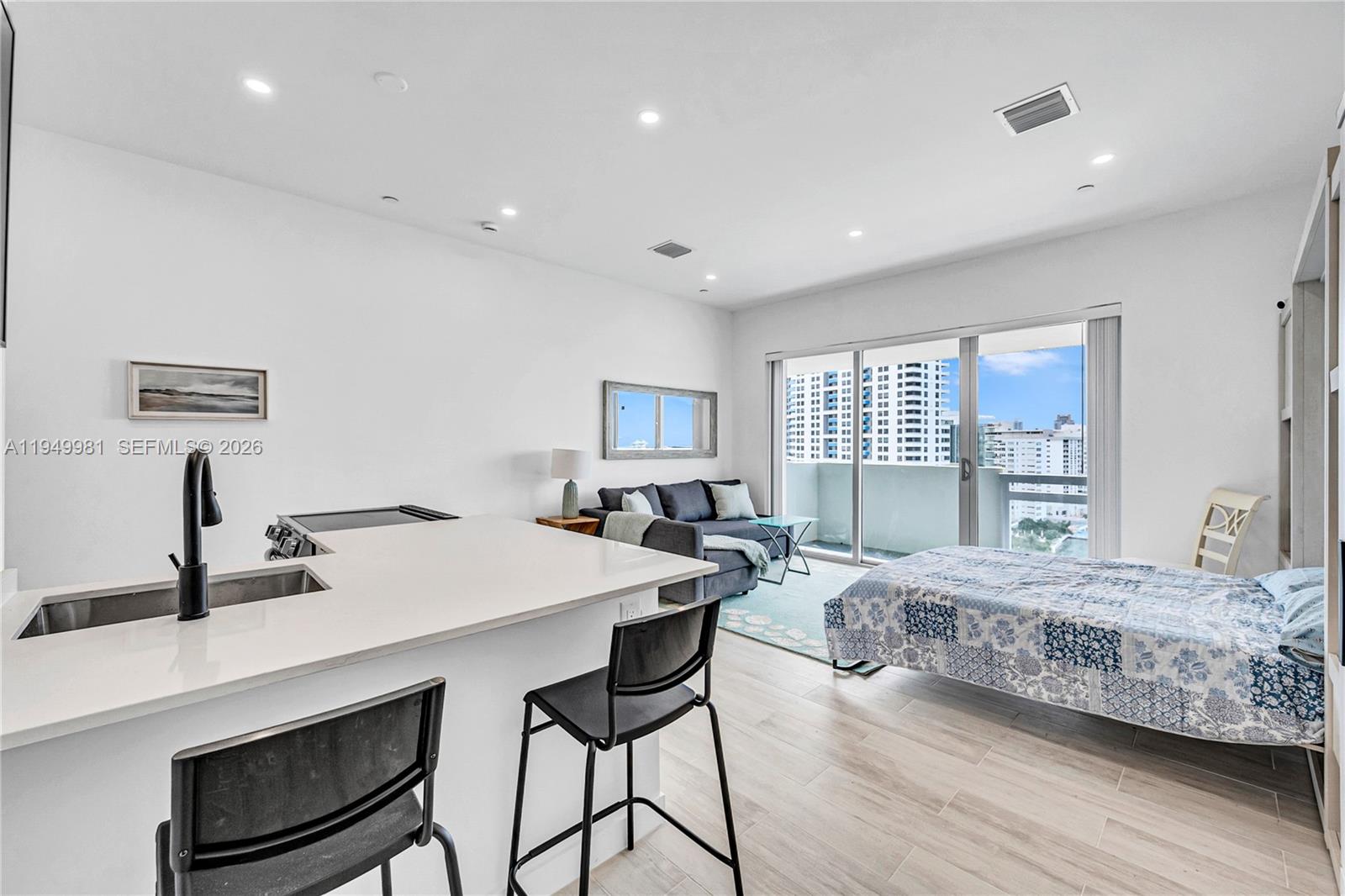1500 Bay Road, Unit 1536S Miami Beach, FL 33139 - Photo 21 of 34 a bedroom with a bed and a table