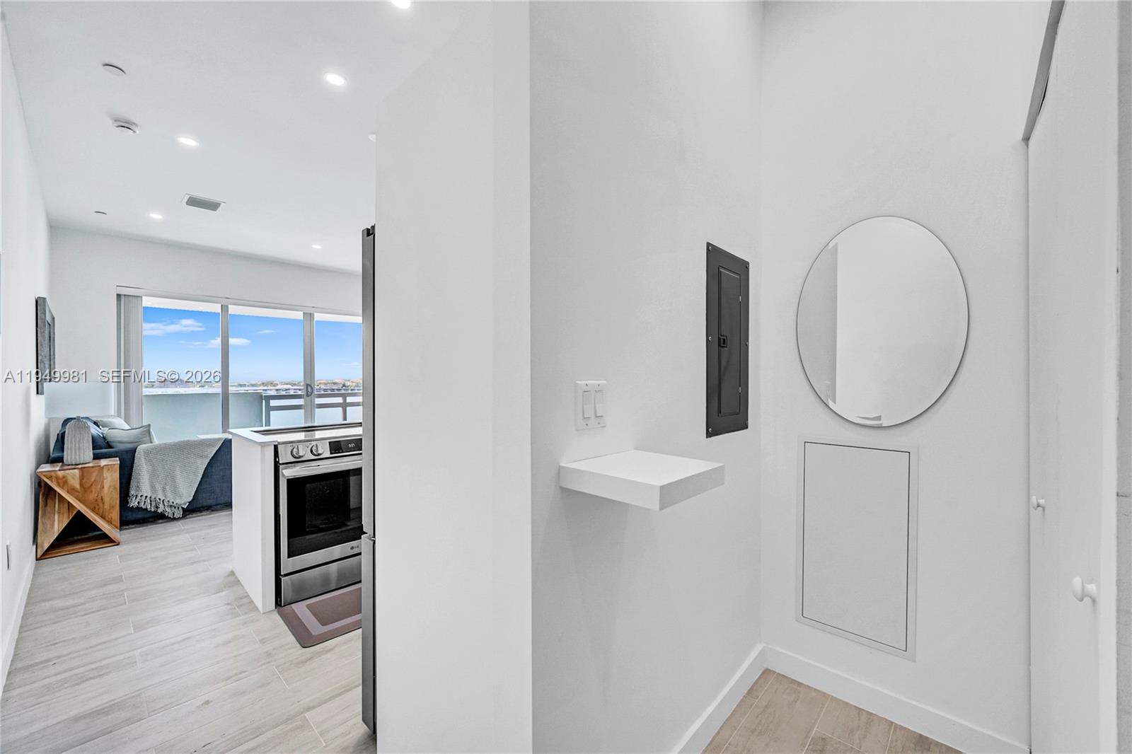 1500 Bay Road, Unit 1536S Miami Beach, FL 33139 - Photo 22 of 34 a kitchen with stainless steel appliances granite countertop a stove a sink and a refrigerator with wooden floor