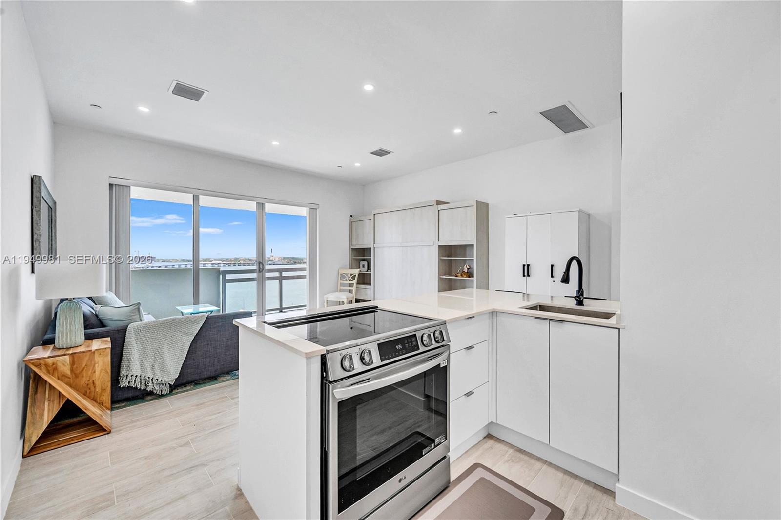 1500 Bay Road, Unit 1536S Miami Beach, FL 33139 - Photo 23 of 34 a kitchen with stainless steel appliances granite countertop a stove and a sink