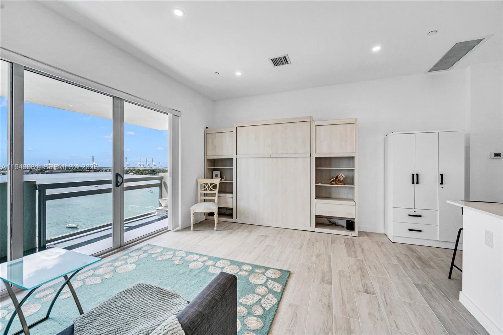 1500 Bay Road, Unit 1536S Miami Beach, FL 33139 - Photo 26 of 34 a kitchen with stainless steel appliances kitchen island granite countertop a refrigerator and cabinets