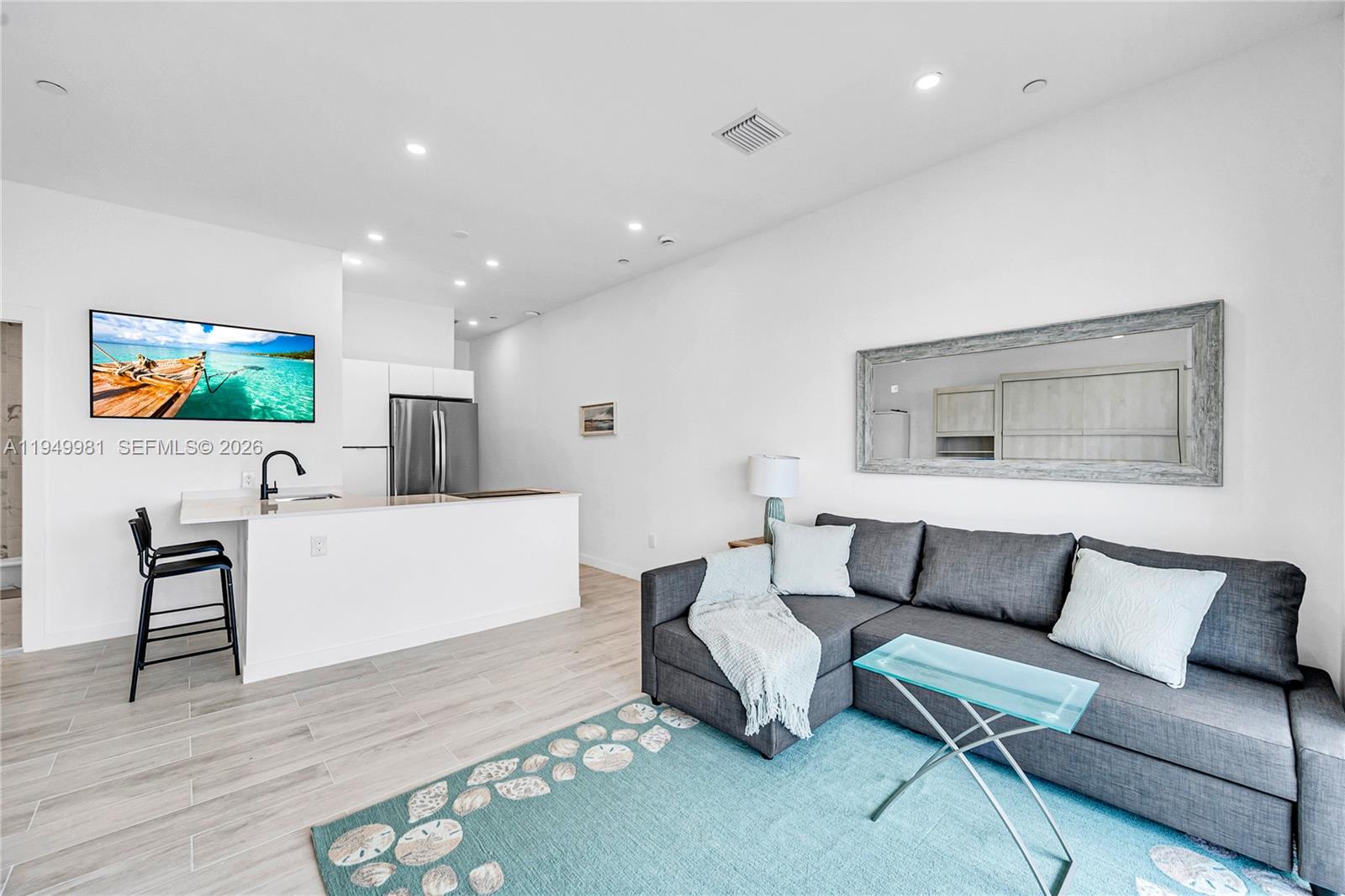 1500 Bay Road, Unit 1536S Miami Beach, FL 33139 - Photo 28 of 34 a living room with furniture and a flat screen tv