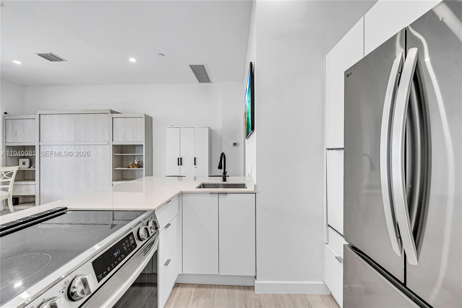 1500 Bay Road, Unit 1536S Miami Beach, FL 33139 - Photo 31 of 34 a kitchen with stainless steel appliances a refrigerator sink and stove