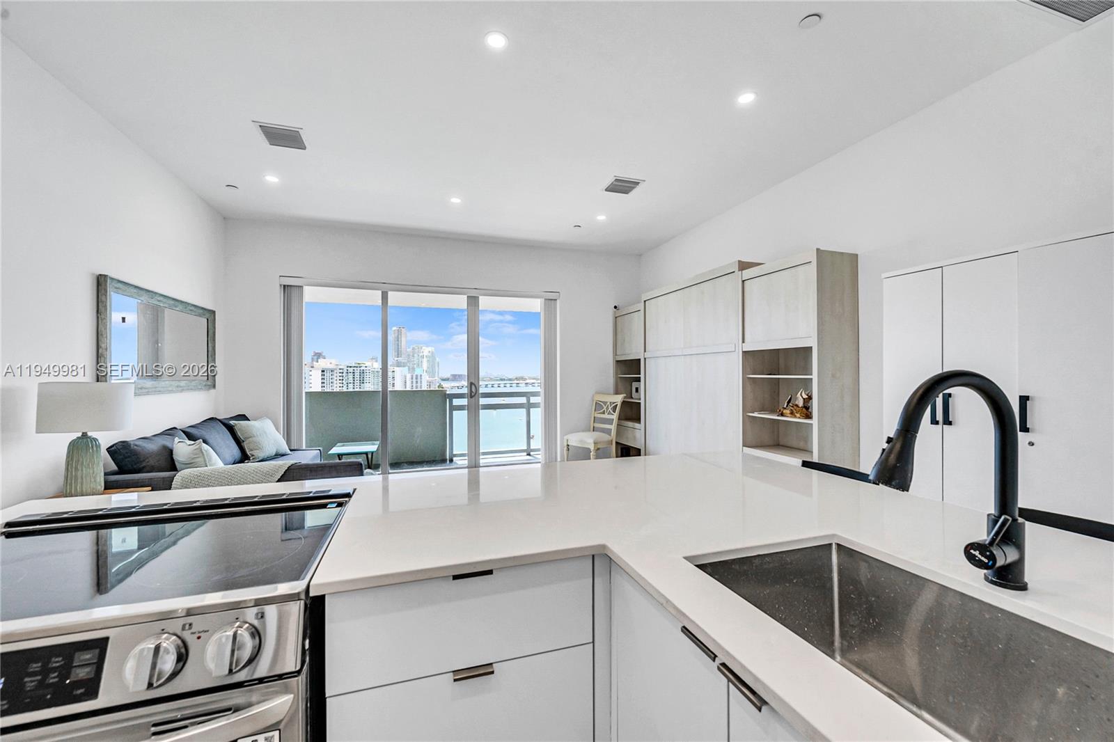 1500 Bay Road, Unit 1536S Miami Beach, FL 33139 - Photo 32 of 34 a kitchen with a stove a sink and a refrigerator