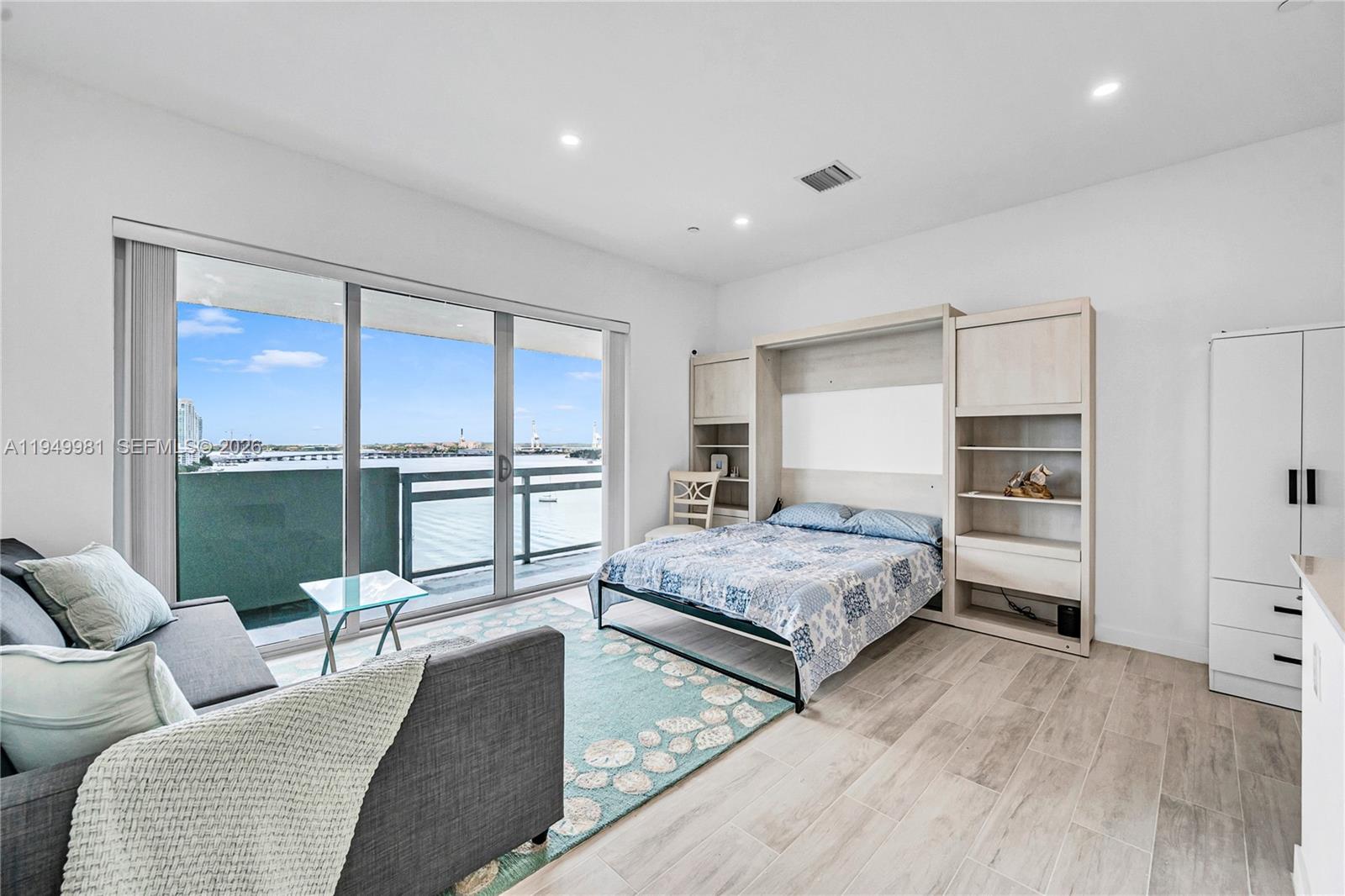 1500 Bay Road, Unit 1536S Miami Beach, FL 33139 - Photo 6 of 34 a living room with furniture and a large window