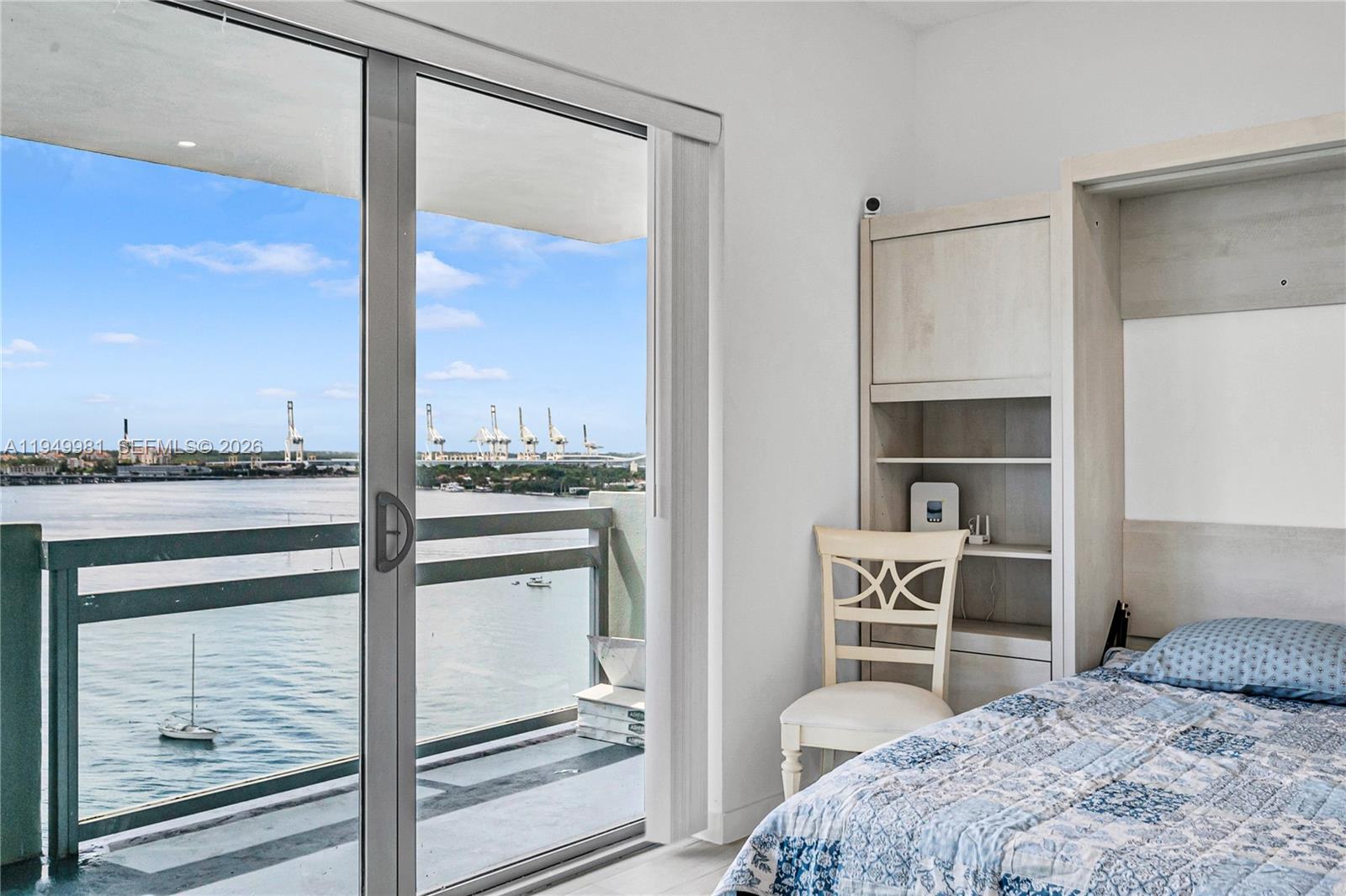 1500 Bay Road, Unit 1536S Miami Beach, FL 33139 - Photo 7 of 34 a bedroom with a bed and a window