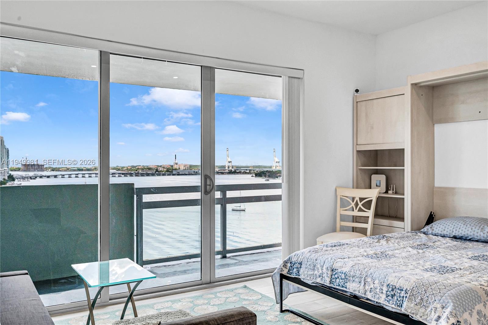 1500 Bay Road, Unit 1536S Miami Beach, FL 33139 - Photo 9 of 34 a bedroom with a bed and a window