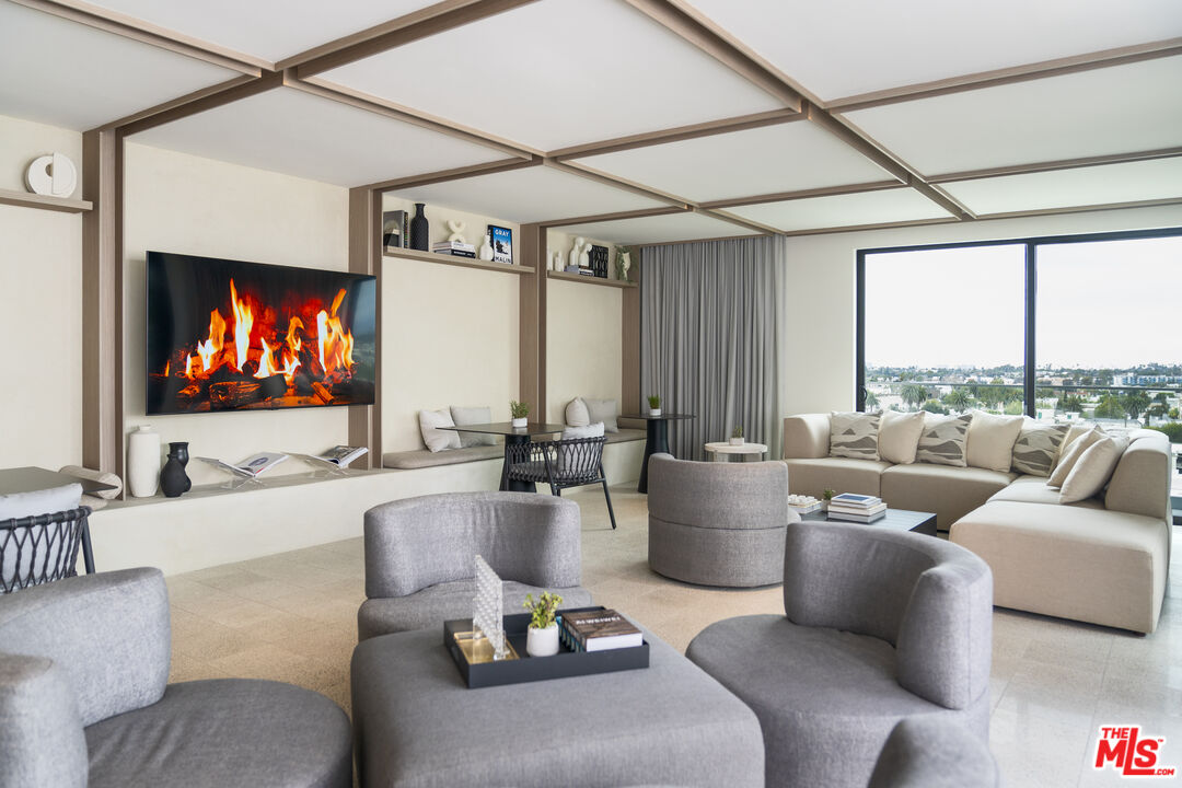 3688 Overland Avenue, Unit 312 Los Angeles, CA 90034 - Photo 19 of 33 a living room with furniture and a flat screen tv