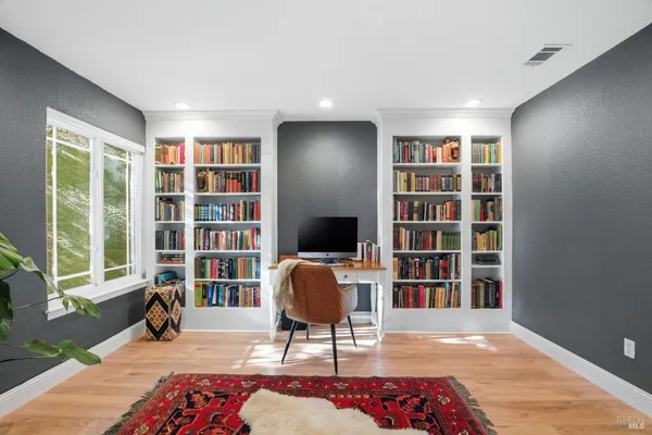 a view of a livingroom with workspace and a window