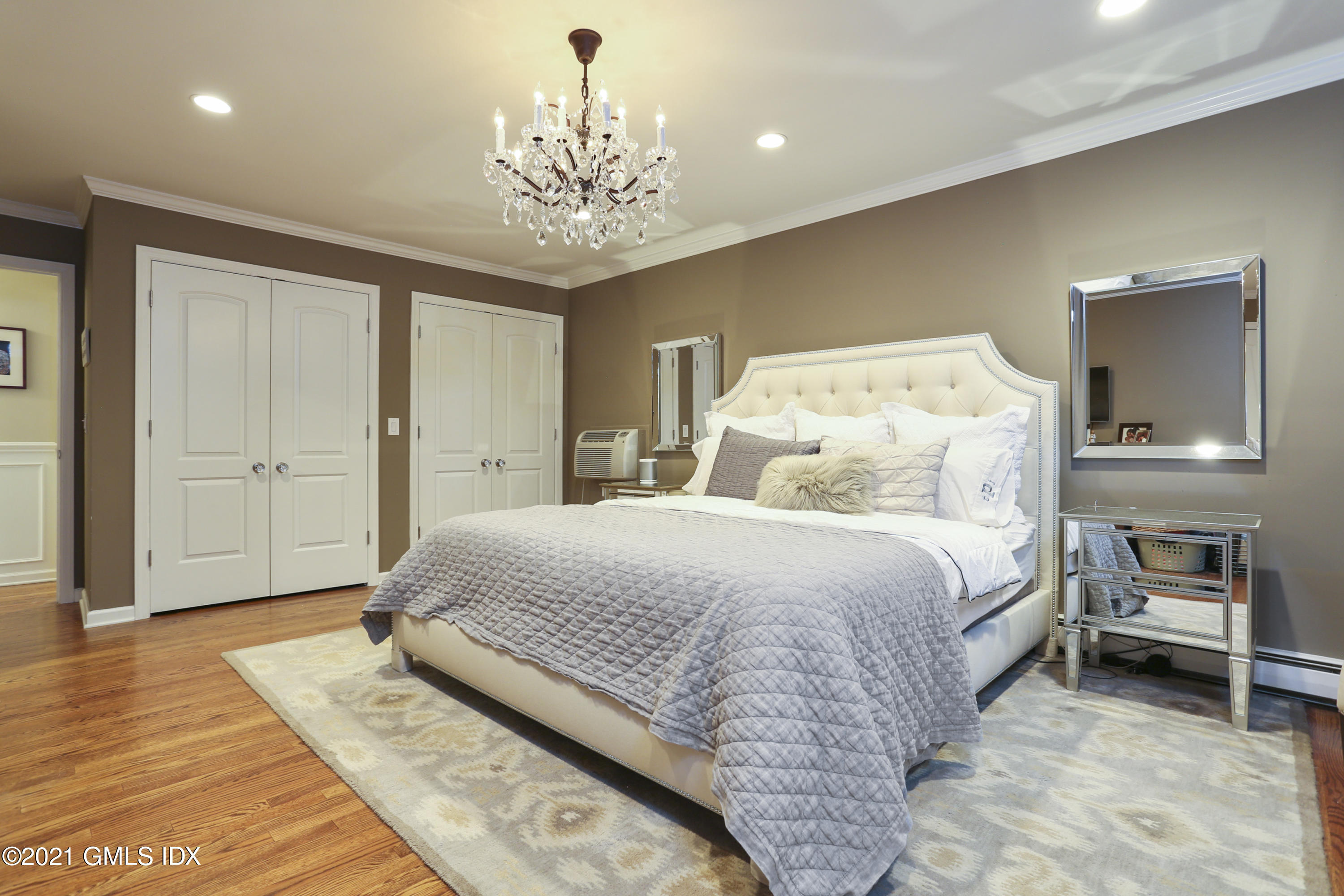 236 Palmer Hill Road Old Greenwich, CT 06870 - Photo 14 of 33 a spacious bedroom with a bed and a chandelier
