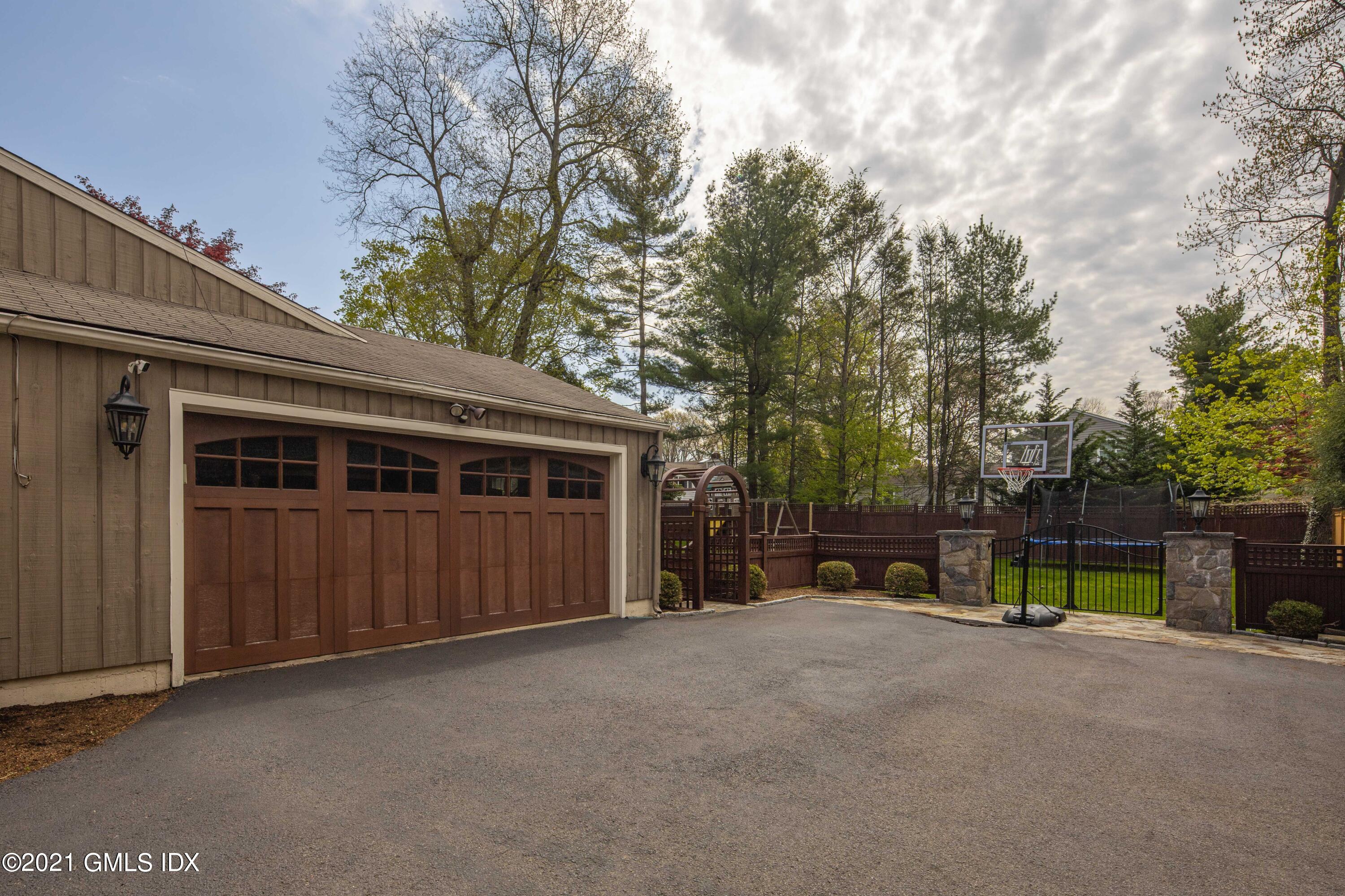236 Palmer Hill Road Old Greenwich, CT 06870 - Photo 30 of 33 a view of a house with backyard and trees
