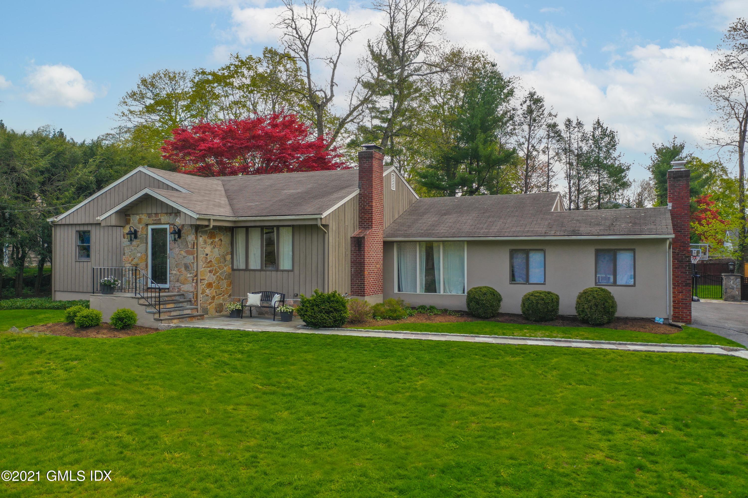 236 Palmer Hill Road Old Greenwich, CT 06870 - Photo 3 of 33 a front view of a house with a garden and trees
