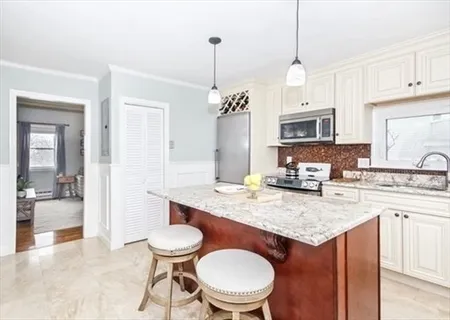 a kitchen with a table chairs stove and cabinets