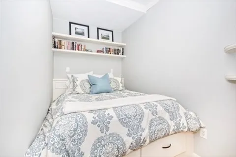 a bedroom with a bed and a book shelf