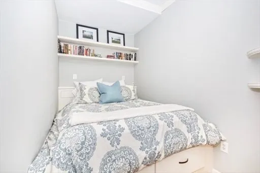 a bedroom with a bed and a book shelf