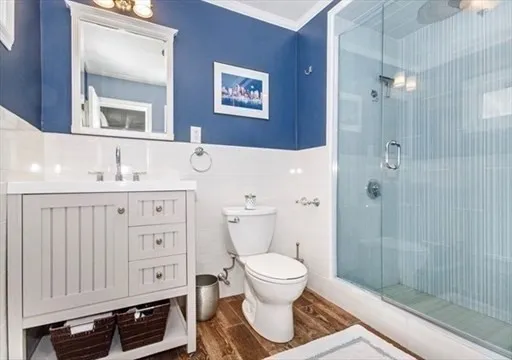 a bathroom with a toilet a sink and glass door