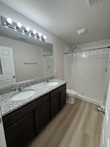 an empty room with wooden floor and window