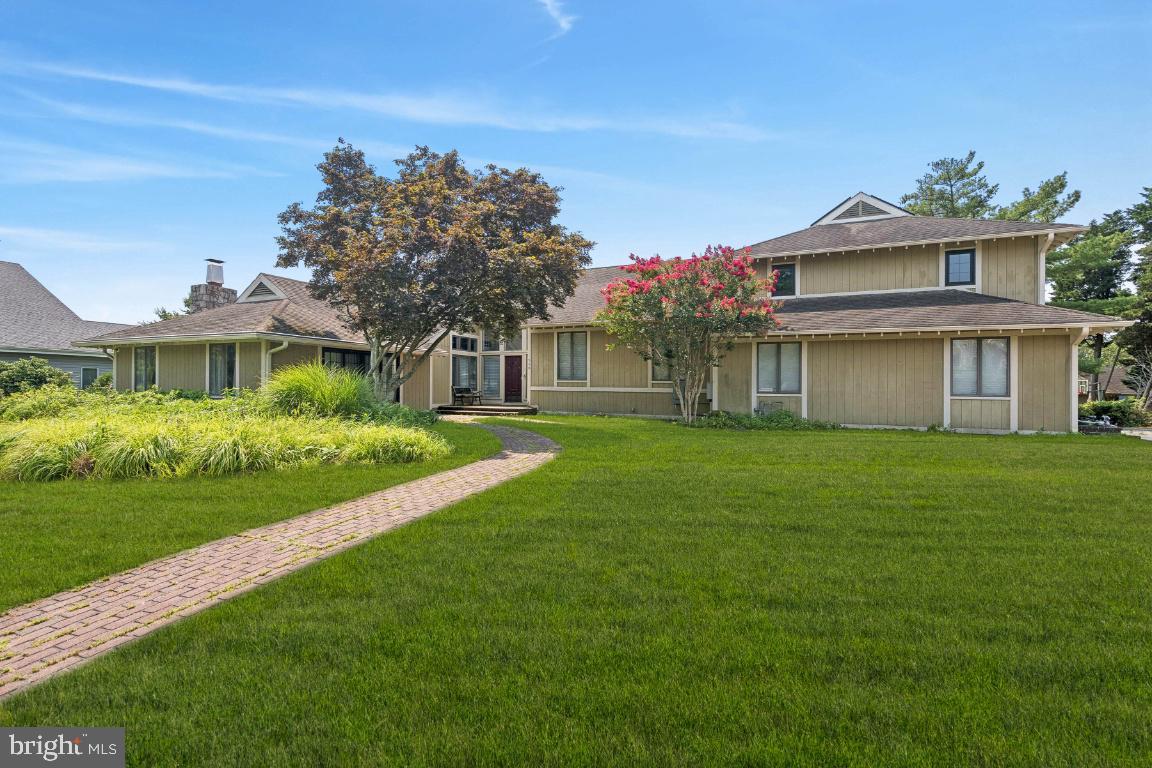 506 Lazy Lane Absecon, NJ 08201 - Photo 1 of 26 a front view of a house with a garden and yard
