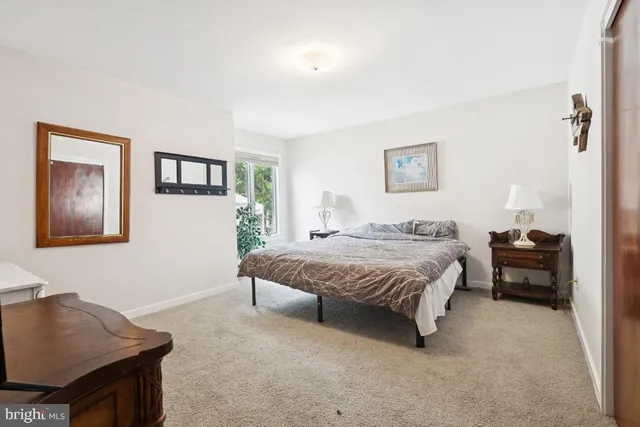 a spacious bedroom with a bed and a desk