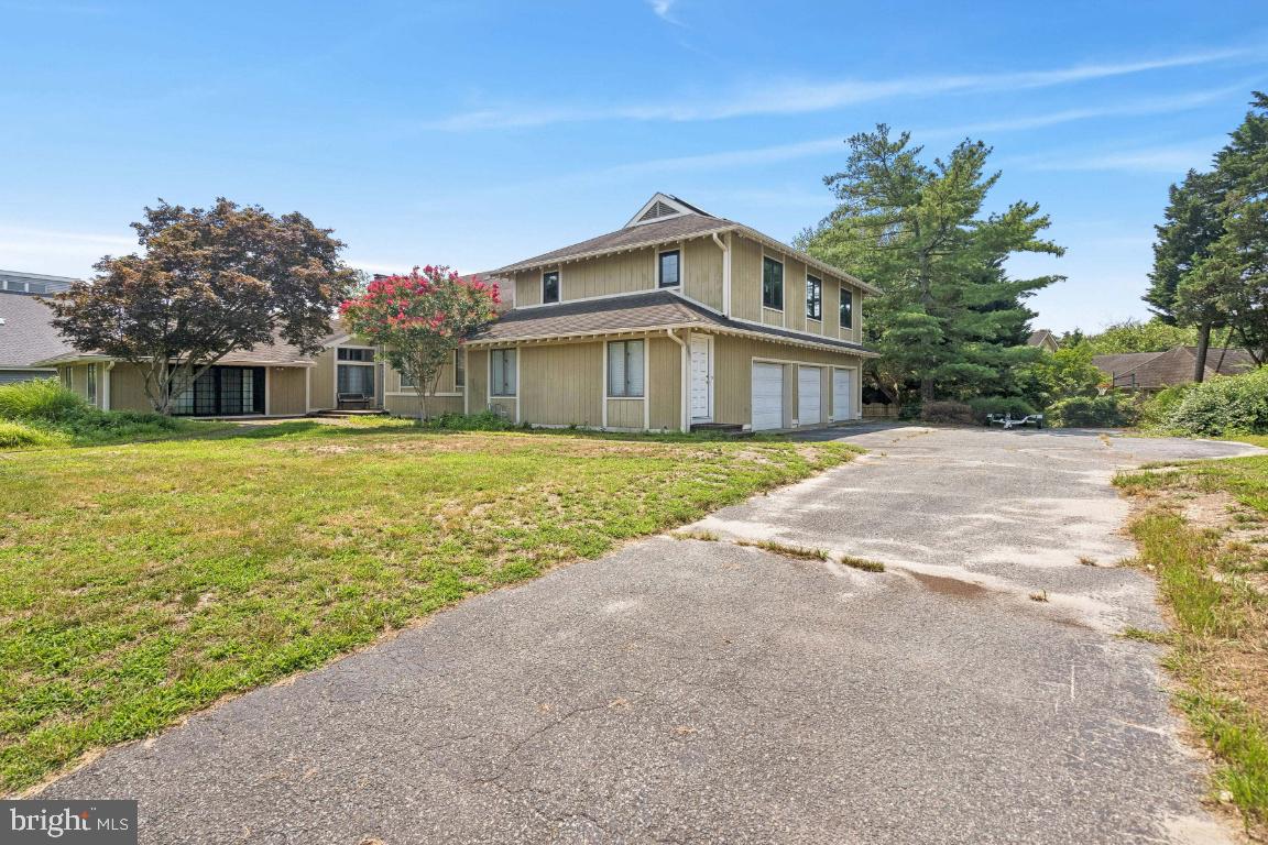 506 Lazy Lane Absecon, NJ 08201 - Photo 2 of 26 a view of a house with a big yard and large trees