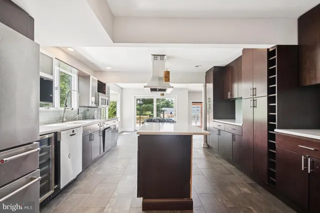 a large kitchen with a large counter top appliances and cabinets