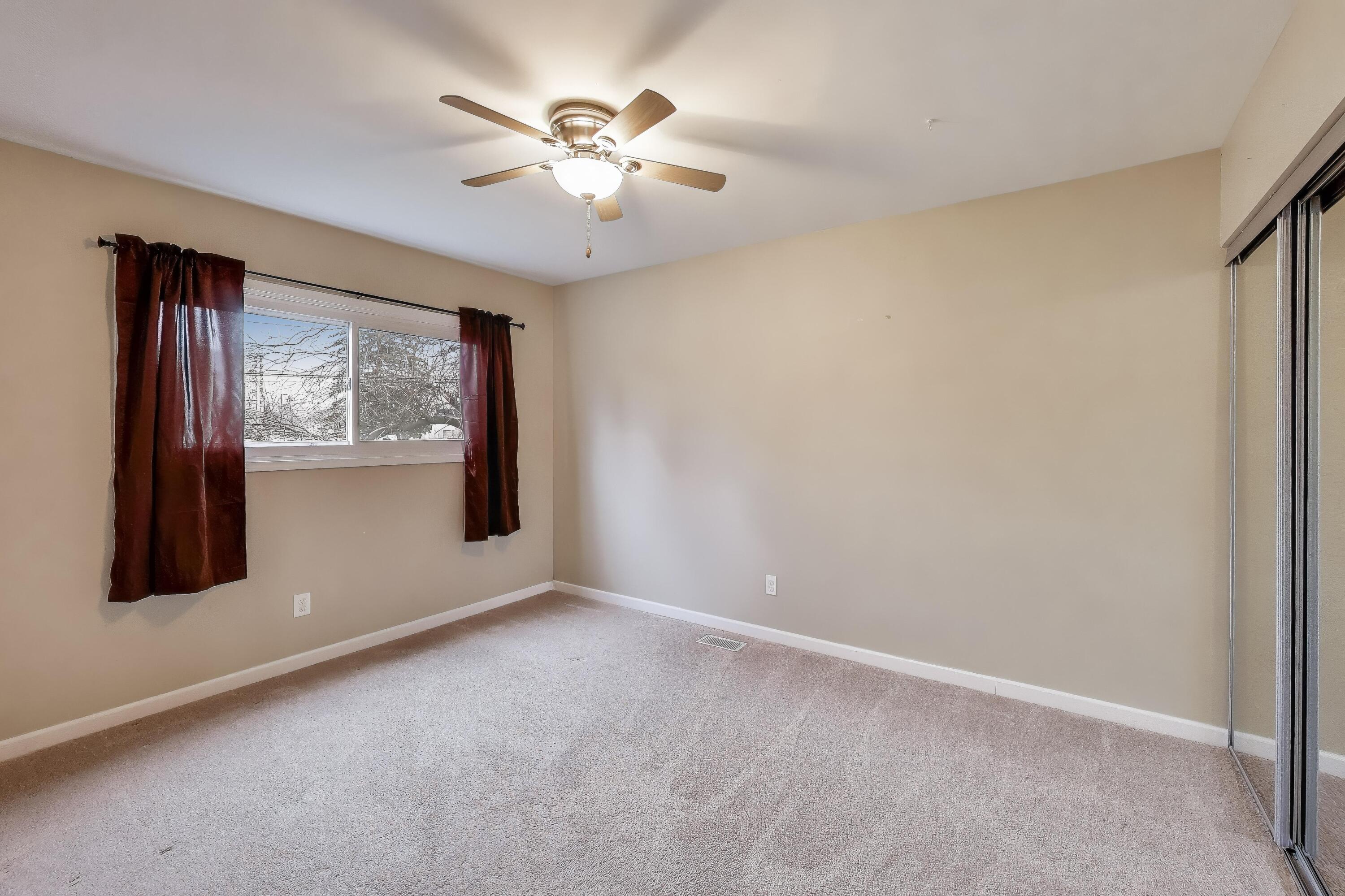 816 East 39th Lane Griffith, IN 46319 - Photo 18 of 42 an empty room with windows and chandelier fan