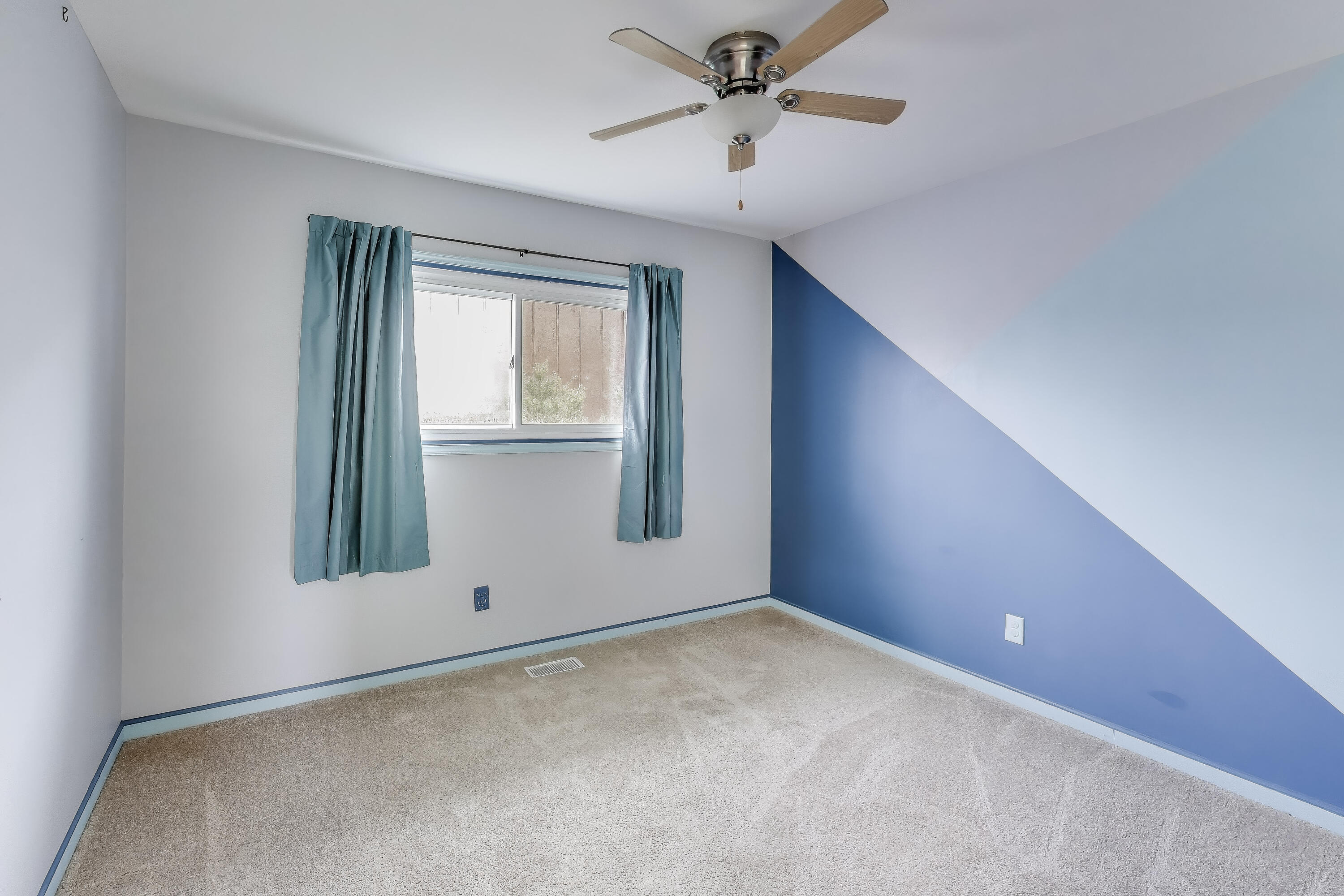 816 East 39th Lane Griffith, IN 46319 - Photo 20 of 42 an empty room with a window and a ceiling fan
