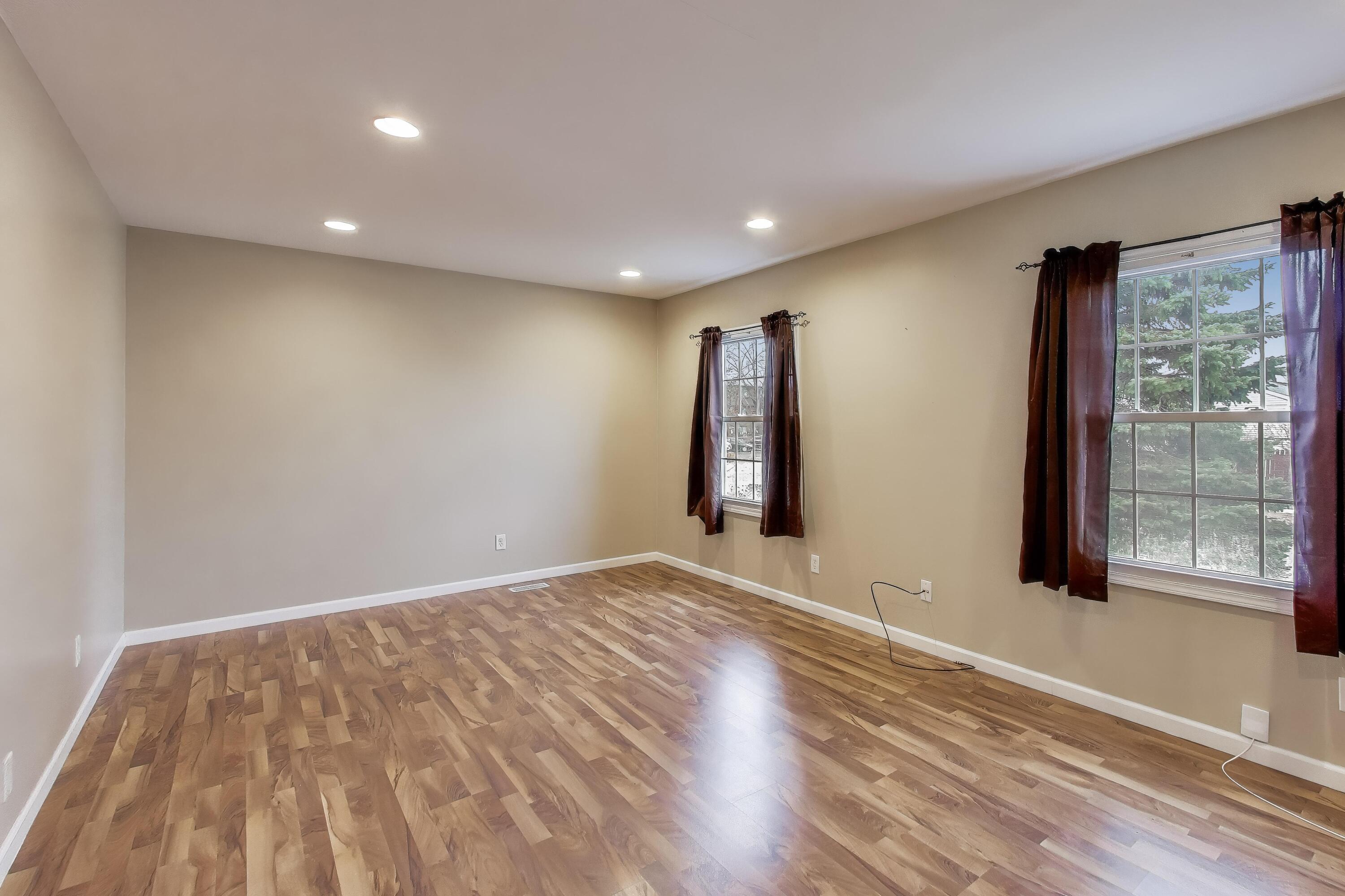 816 East 39th Lane Griffith, IN 46319 - Photo 5 of 42 a view of an empty room with wooden floor and a window
