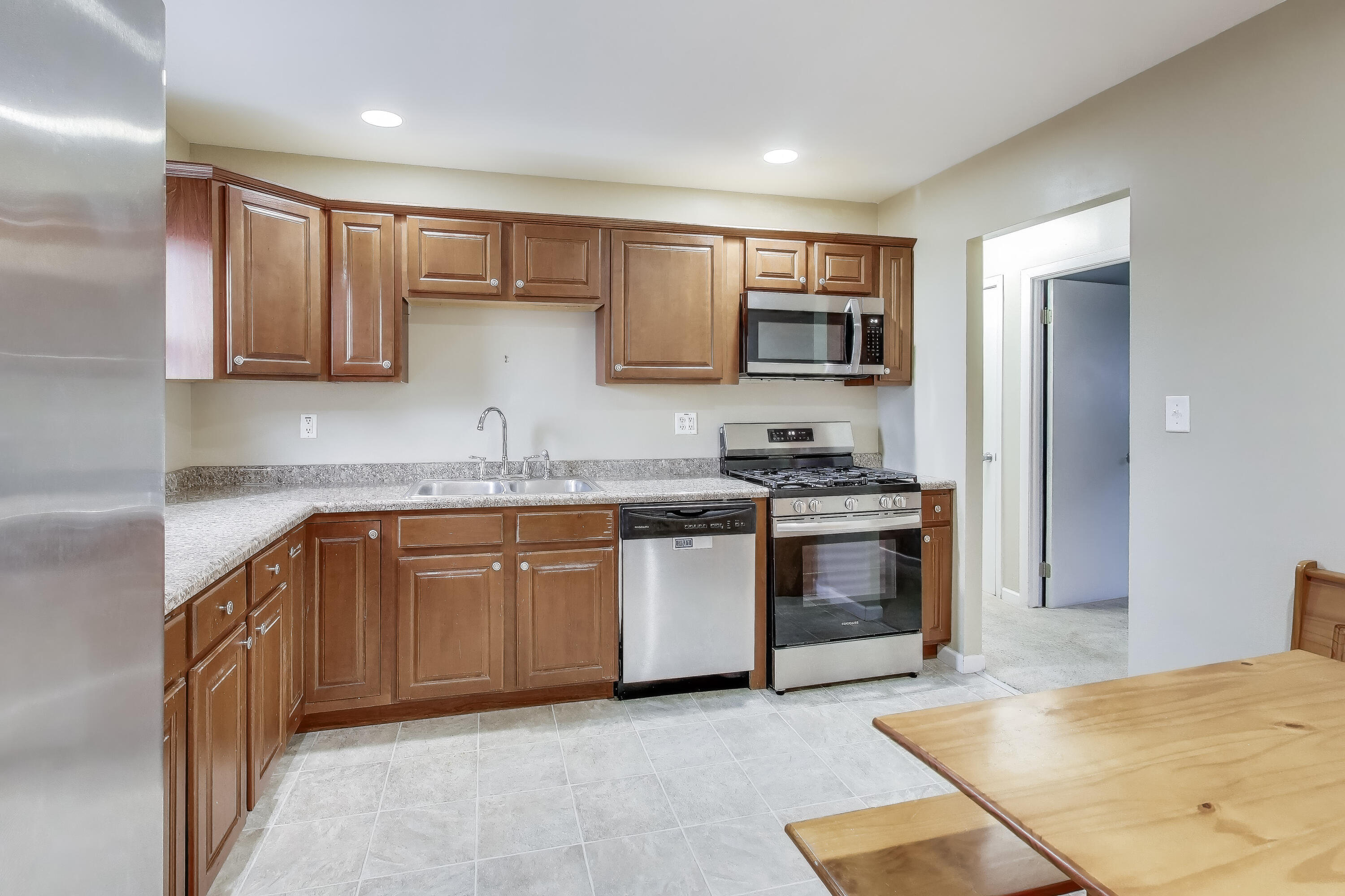 816 East 39th Lane Griffith, IN 46319 - Photo 10 of 42 a kitchen with stainless steel appliances granite countertop a stove top oven a sink and dishwasher
