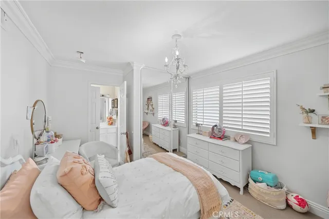 a bed room with a bed and a chandelier