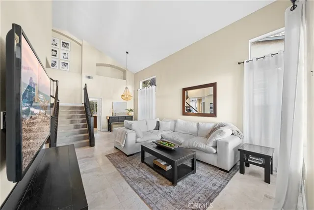 a living room with furniture wooden floor and a large window