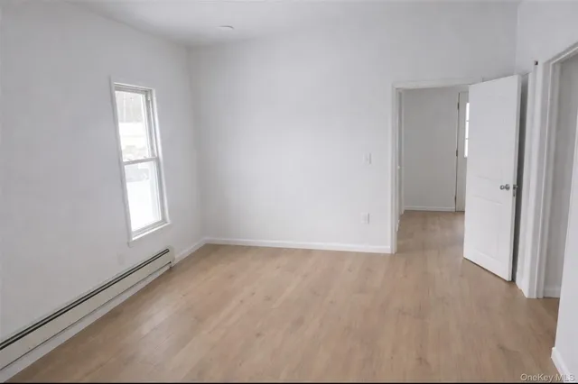 an empty room with windows and closet
